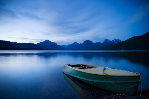 A boat on a still lake recalls Longfellow's quote about disenfranchised grief.