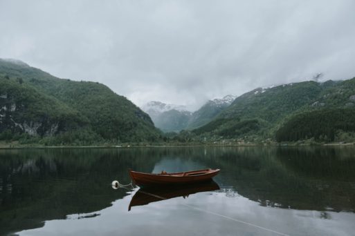 boat in a lake next to the mountains