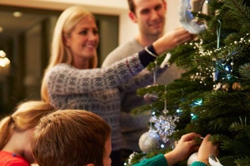 Family decorating Christmas tree overcoming grief