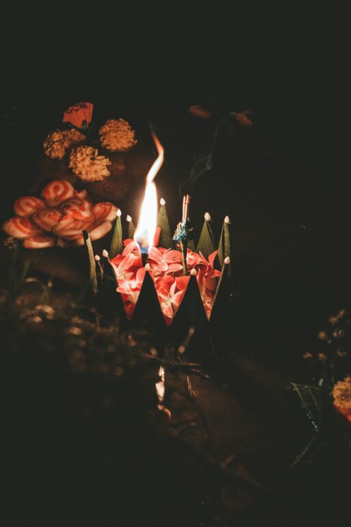 Pinl valentimes day flowers with candles about history of Valentine’s Day being fraught with love, death and trial