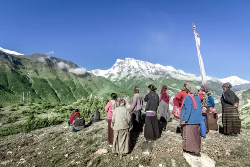 group of women watching as a Tibetan Buddhist sky Burial Ritual begins