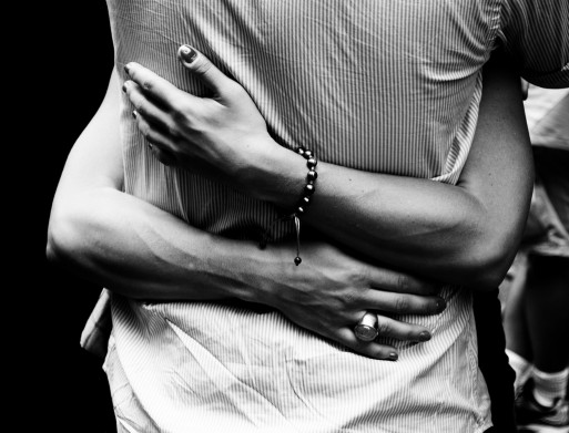 A woman hugging a man 