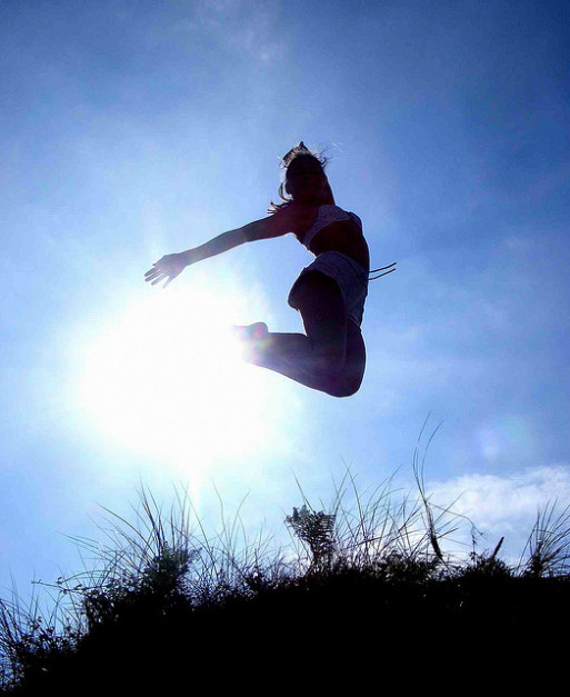 A girl jumping in a field