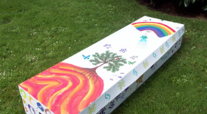 A cardboard coffin lovingly decorated by family