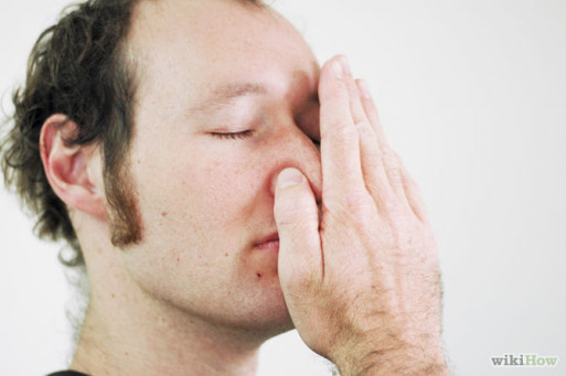 Man demonstrates hand position for left nostril breathing