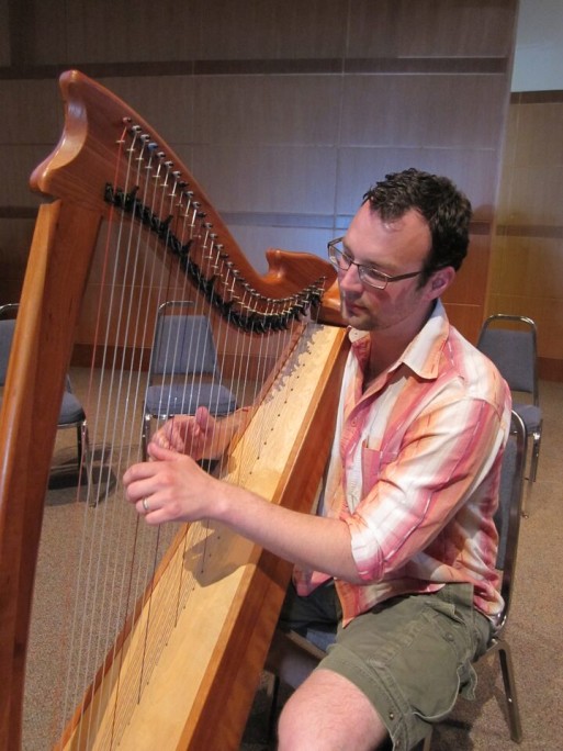 Kieran Schnabel, music thanatologist with Sacred Flight, playing harp