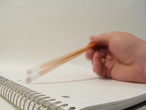 Someone tapping a pencil on a blank paper while estate planning