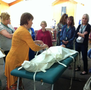 Wrapping a body in a shroud demonstration at National Home Funeral Alliance Conference