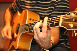 A man playing an acoustic guitar
