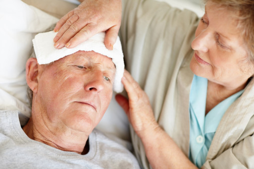 Caregiving wife soothing husband in palliative care