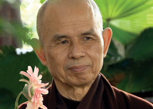Thich Nhat Hanh with a pink chrysanthemum 