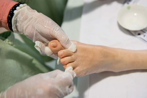 Caring hands massage the feet of a patient in palliative care