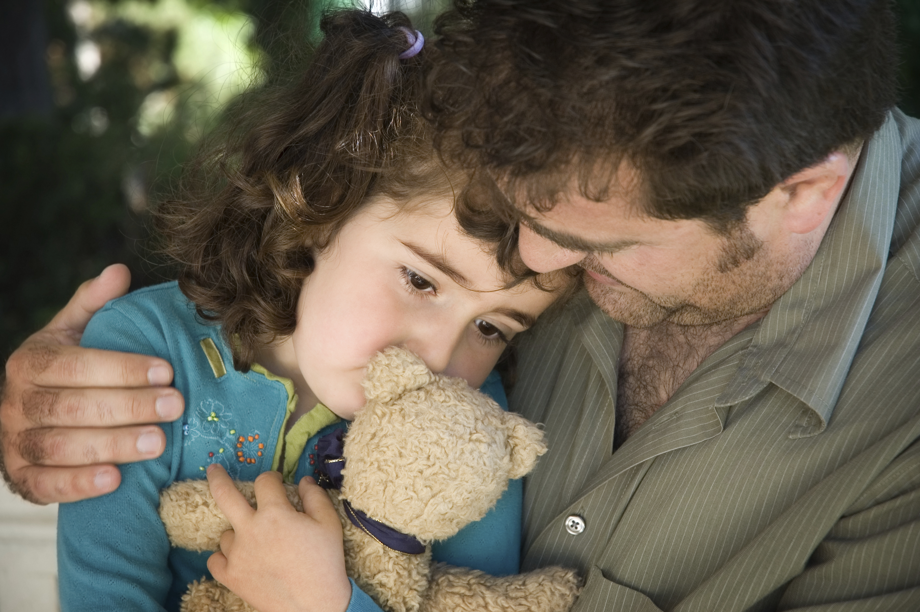 father comforting a young girl after a death