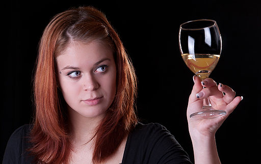 A woman holding a glass of wine
