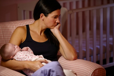 Mother with postpartum depression holding baby