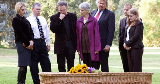 Family at a wider casket at a green burial