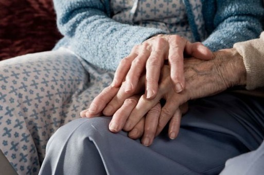 hands of aging couple intertwined