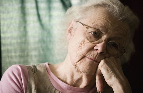 Elderly woman with dementia staring into space
