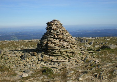 A cairn or ancient burial mound made of piled stones