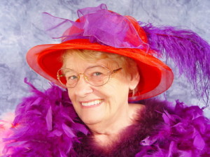 A member of the Red Hat Society dressed in purple and red