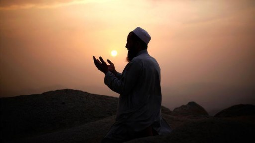 A Muslin man praying at sunset for someone who has died 