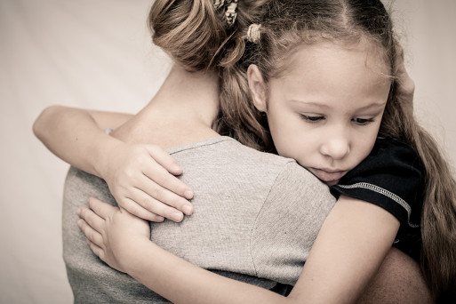 Parent comforts a grieving child