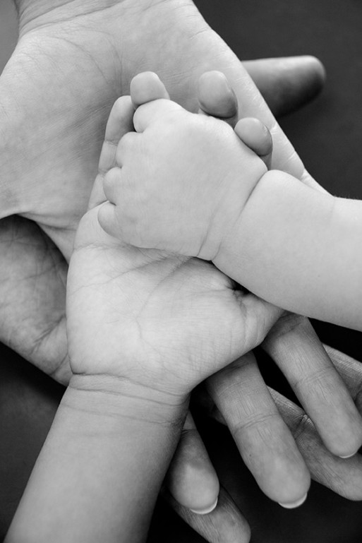 Hands of three generations reflect loving care of those who are dying