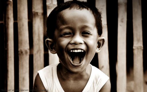 Little boy laughing despite death or grief