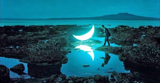 dream-like photo of a person, tidepool and moon shows grief journey