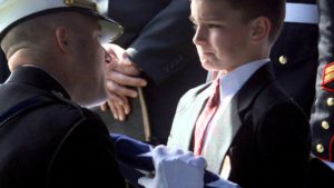 Military funeral rituals comfort young boy