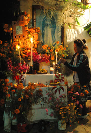 Woman at Day of the Dead altar
