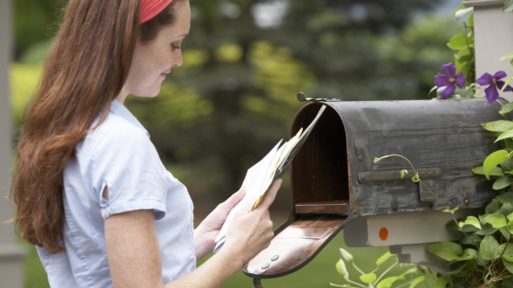 Woman getting her mail to be sure of no fraud