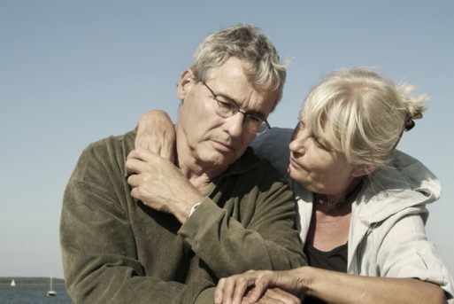 Woman comforting a bereaved man