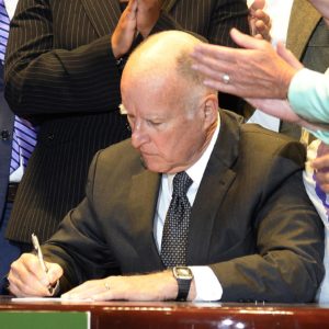 Gov. Brown signs the End of Life Options Act (Credit: vice.com)
