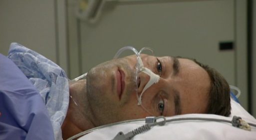 Stephen Heywood lying on a hospital bed waiting for treatment in the ALS documentary about his life