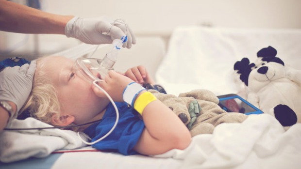 Child getting breathing treatment for terminal illness