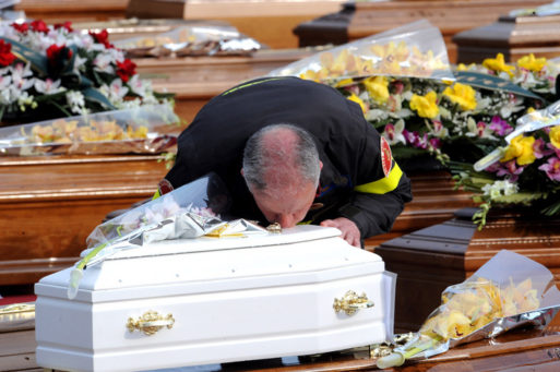 Man kisses the coffin of a child