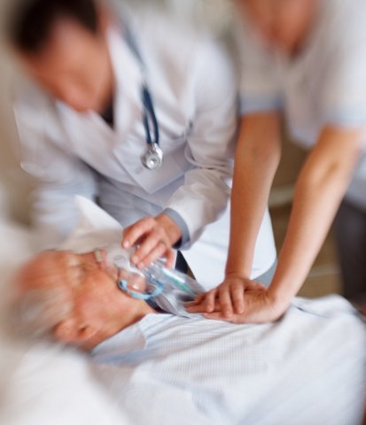 Doctors performing CPR on an elderly man