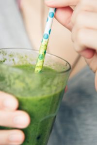 person with dysphagia drinking a thick drink through a straw