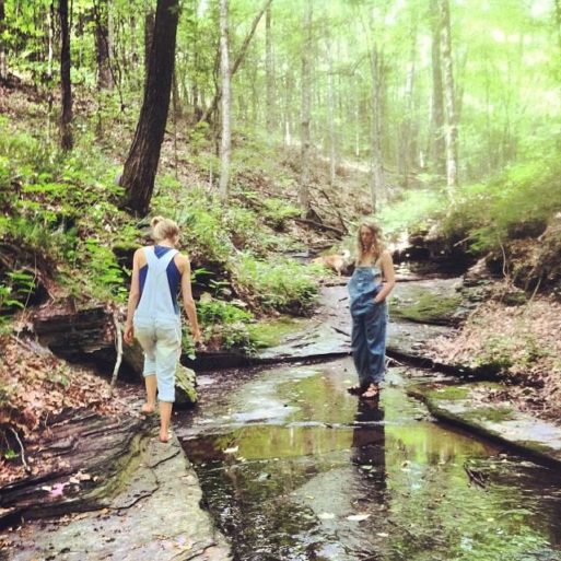 two women walking along a stream enjoying life