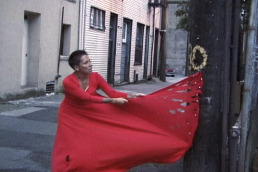 Rebecca Belmore tearing a red dress as an expression of grief in Vigil