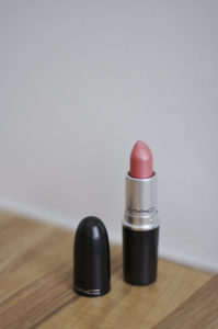 A tube of lipstick sitting on a table, similar to the photographs Ruibal used in her art about death and grief