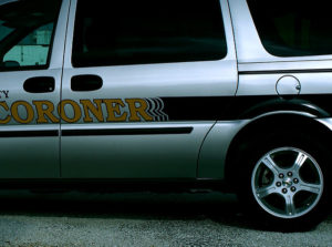 A coroner vehicle driving along the road
