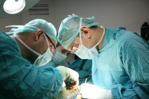 Two surgeons performing an organ transplant