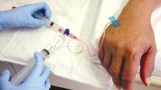 Healthcare worker injecting cyclophosphamide into a cancer patient, germs improve the efficacy of cancer drugs