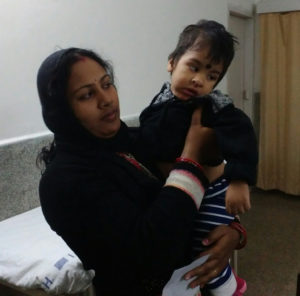 A caregiver and mother holds her son, who has developmental disabilities