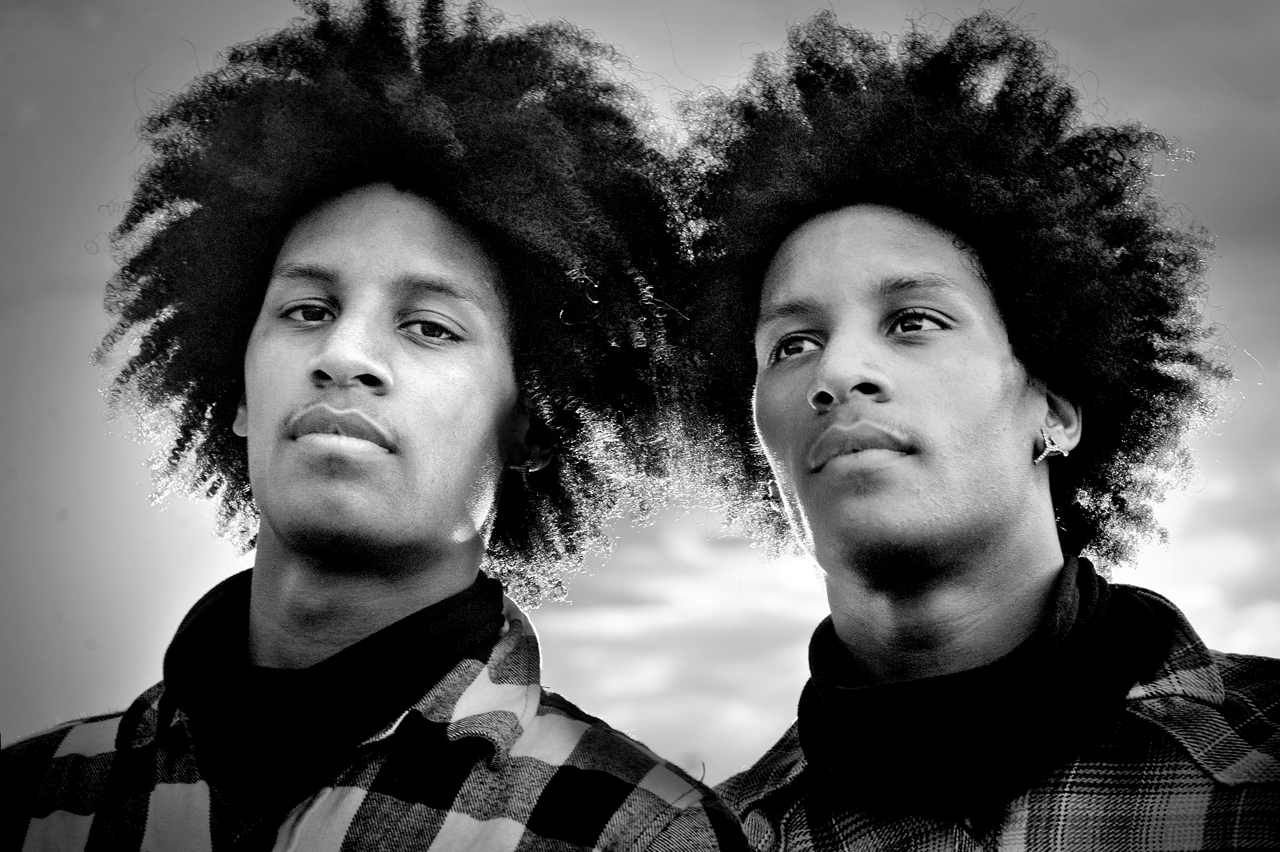 Twin brothers stand next to each other