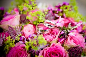 Wedding bands resting on top of flowers can be found at funeral home weddings 