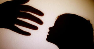 A silhouette of a hand reaching for a child depicts Emma's abuse in Flying in Place 