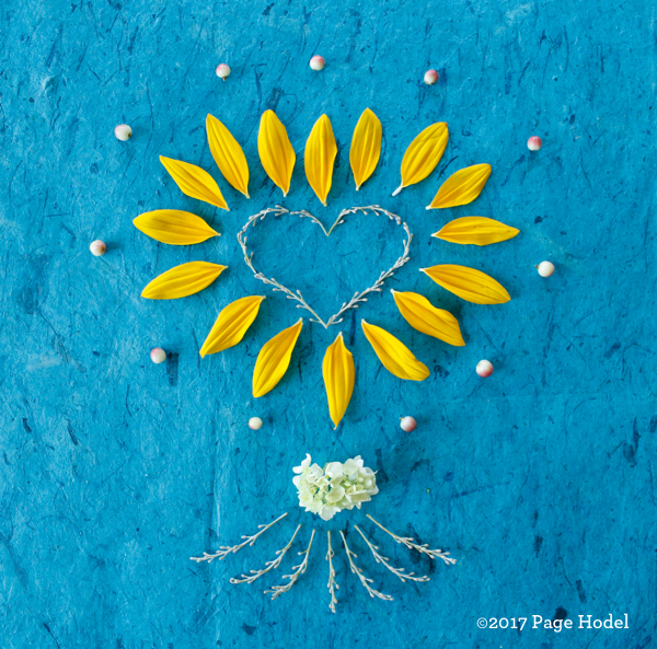 handmade hear of flowers surrounded by blue